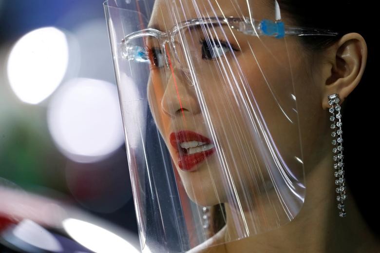 A promoter wears a face shield during the 41st Bangkok International Motor Show, after the Thai government eased measures to prevent the spread of the coronavirus in Bangkok, Thailand. REUTERS/Jorge Silva